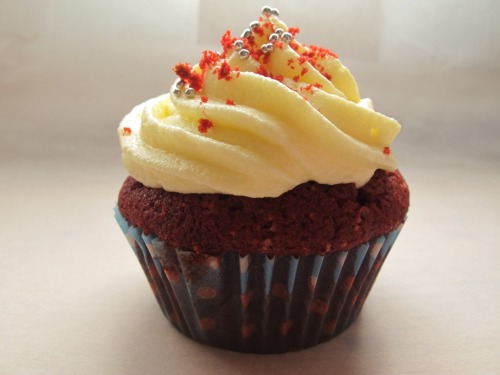a red velvet cupcake with cream cheese frosting